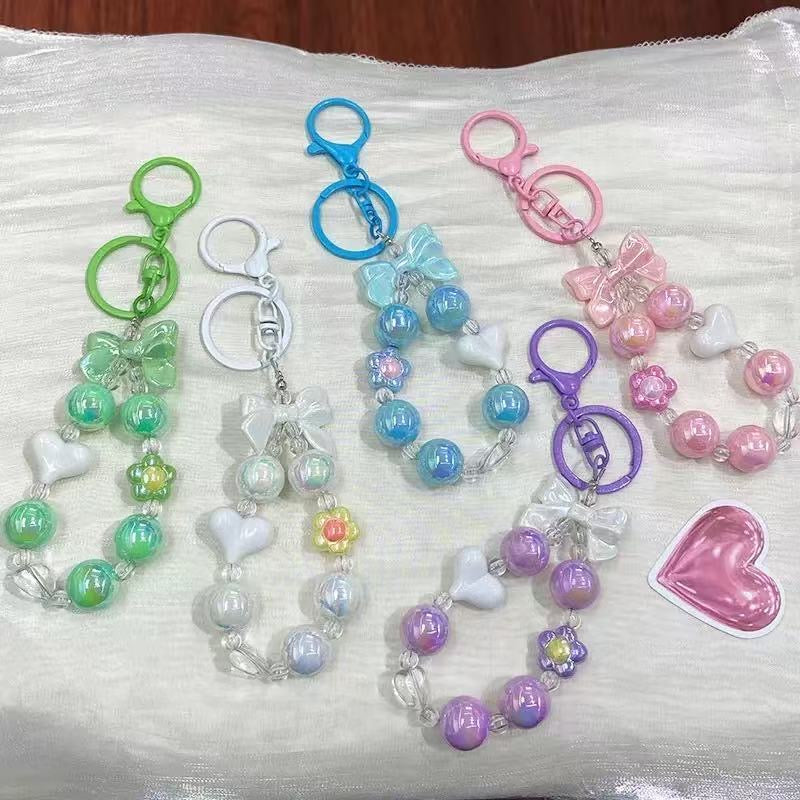Charming, fresh-style candy-colored iridescent beaded keychain featuring butterfly, heart, and "hug" charms.