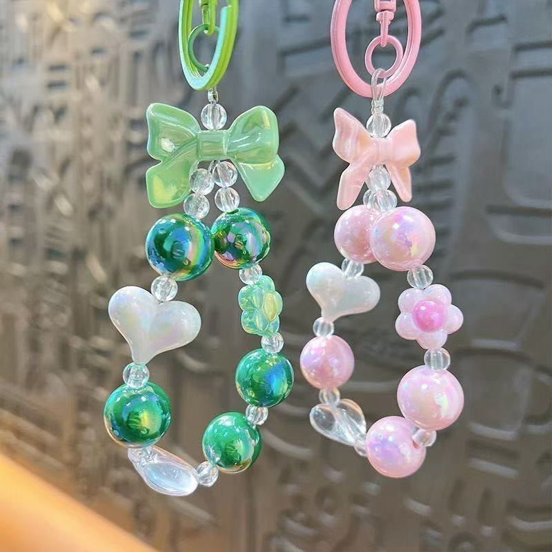 Charming, fresh-style candy-colored iridescent beaded keychain featuring butterfly, heart, and "hug" charms.