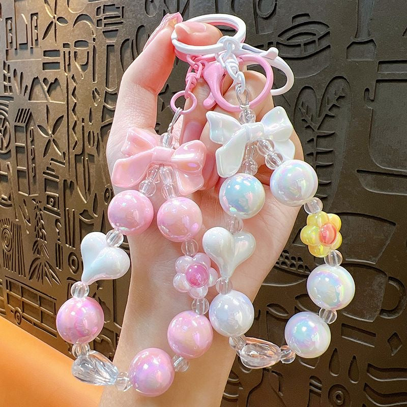 Charming, fresh-style candy-colored iridescent beaded keychain featuring butterfly, heart, and "hug" charms.