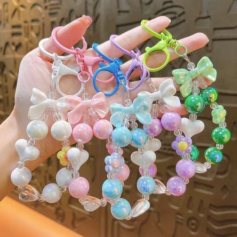 Charming, fresh-style candy-colored iridescent beaded keychain featuring butterfly, heart, and "hug" charms.