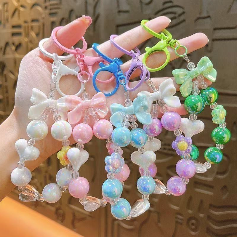 Charming, fresh-style candy-colored iridescent beaded keychain featuring butterfly, heart, and "hug" charms.